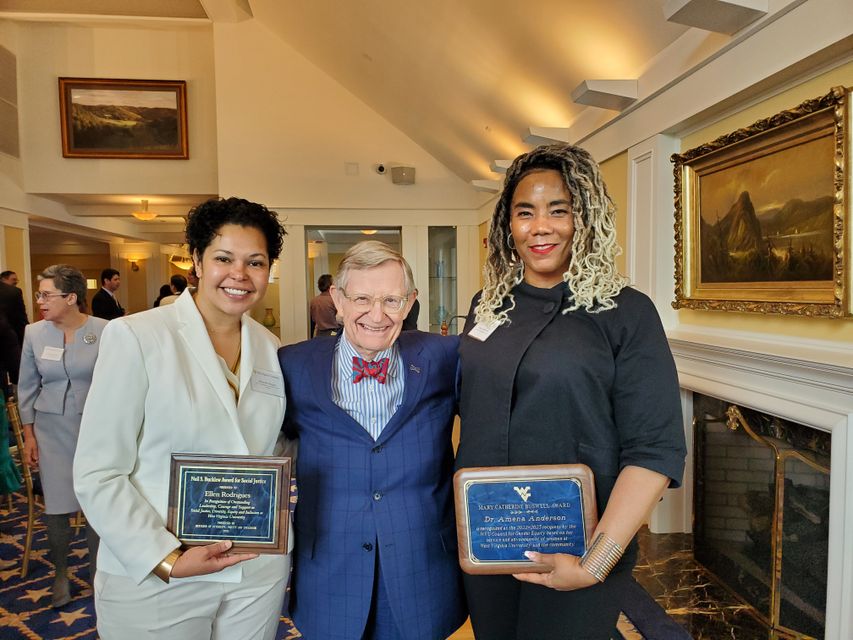 Dr. Amena Anderson holding 2023 Mary Catherine Buswell Award