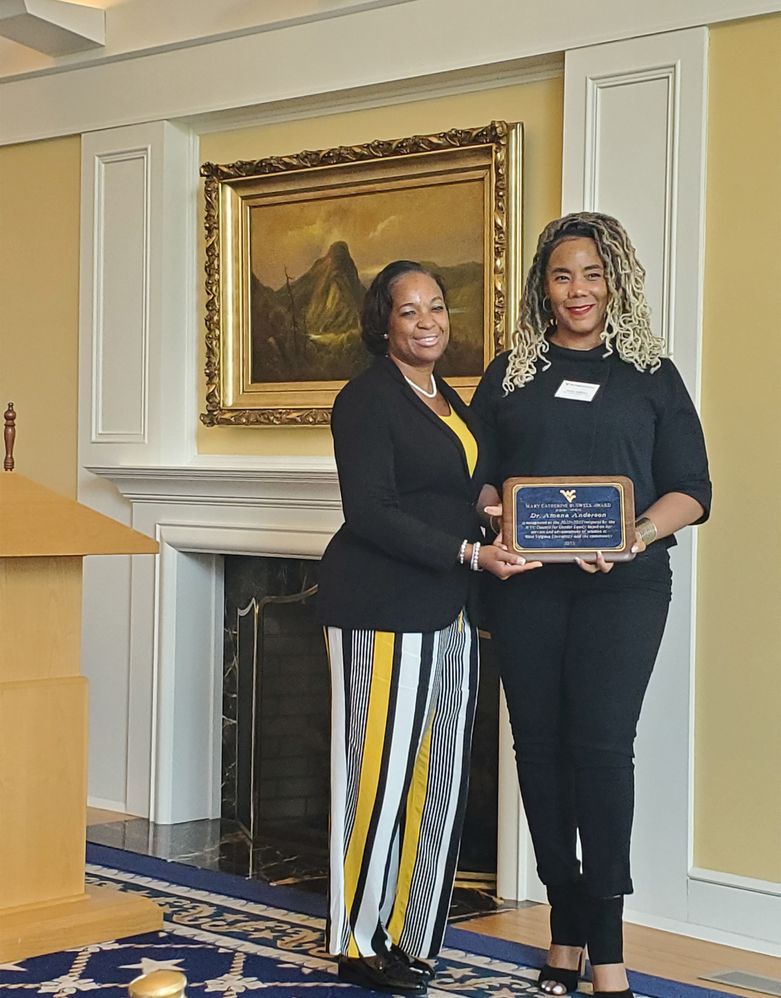 Dr. Amena Anderson holding 2023 Mary Catherine Buswell Award 